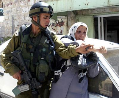 al_Khalil_162_August_29_2003_An_Israeli_soldier_aggressions_at_a_woman_Photo_by_Nayef_Hashlamoun.jpg